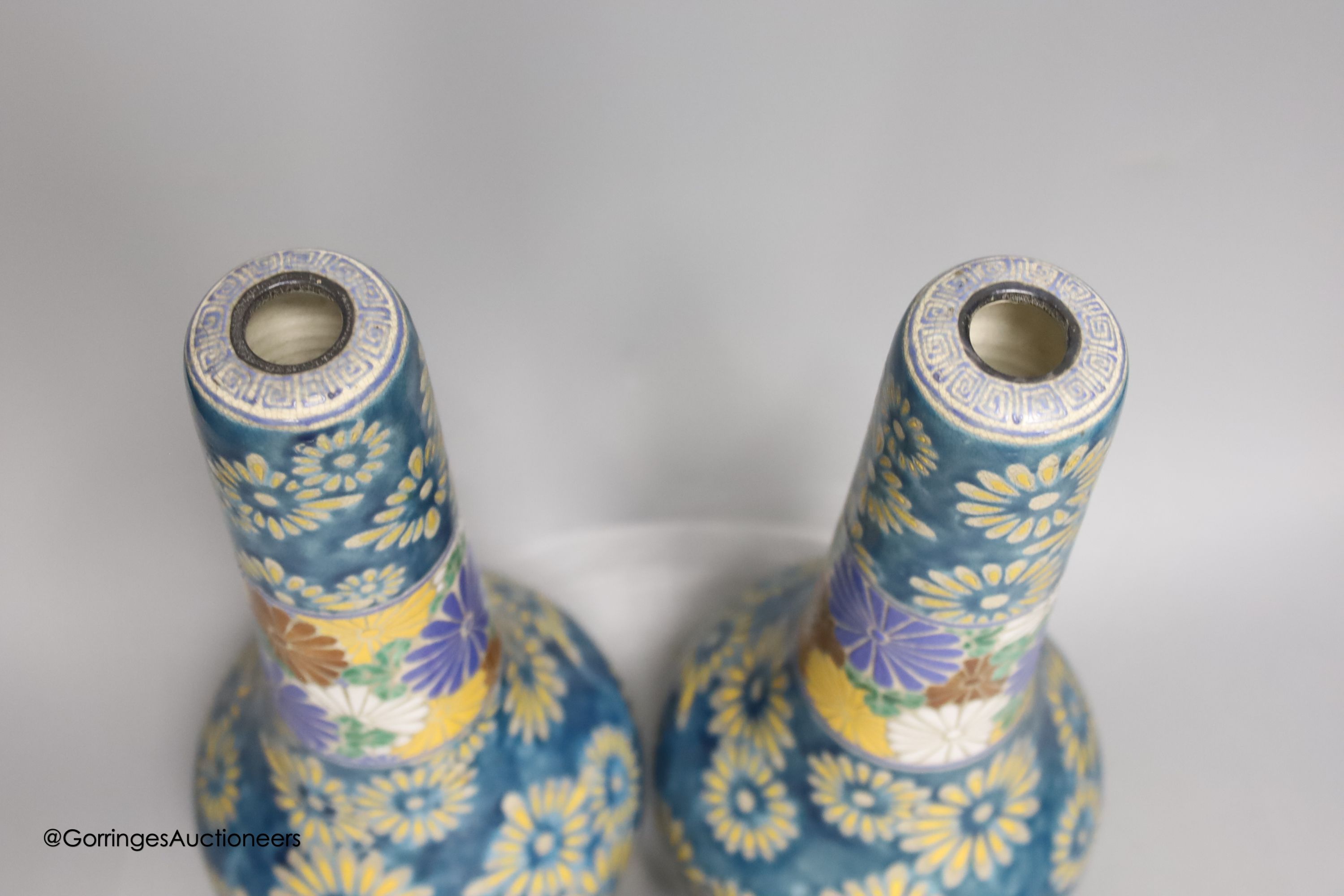 A pair of Japanese Satsuma pottery bottle vases by Taizan Yohei IX, 30cm and a miniature Satsuma vase